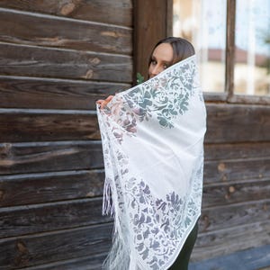 Elegant white lace shawl with fringe