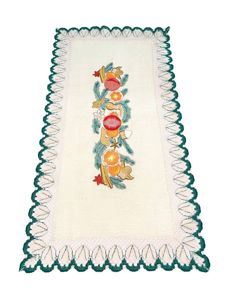May include: Cream-colored rectangular table runner with a green scalloped border. The center features an embroidered design of oranges, red ornaments, and gingerbread cookies, accented with green sprigs and star shapes.