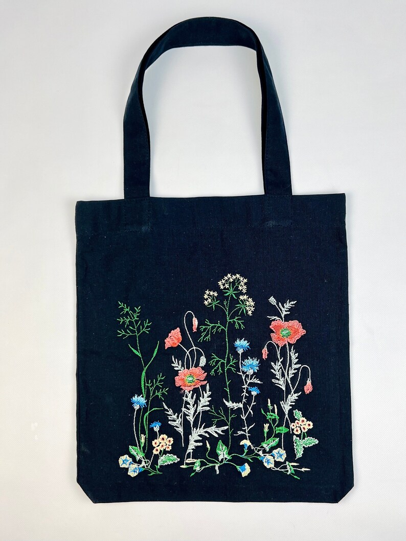 Black canvas tote with embroidered wildflowers, poppies and cornflowers, reusable cotton shoulder bag for shopping, books, market and gifts