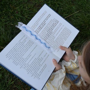 Embroidered fabric bookmark with blue cross stitch