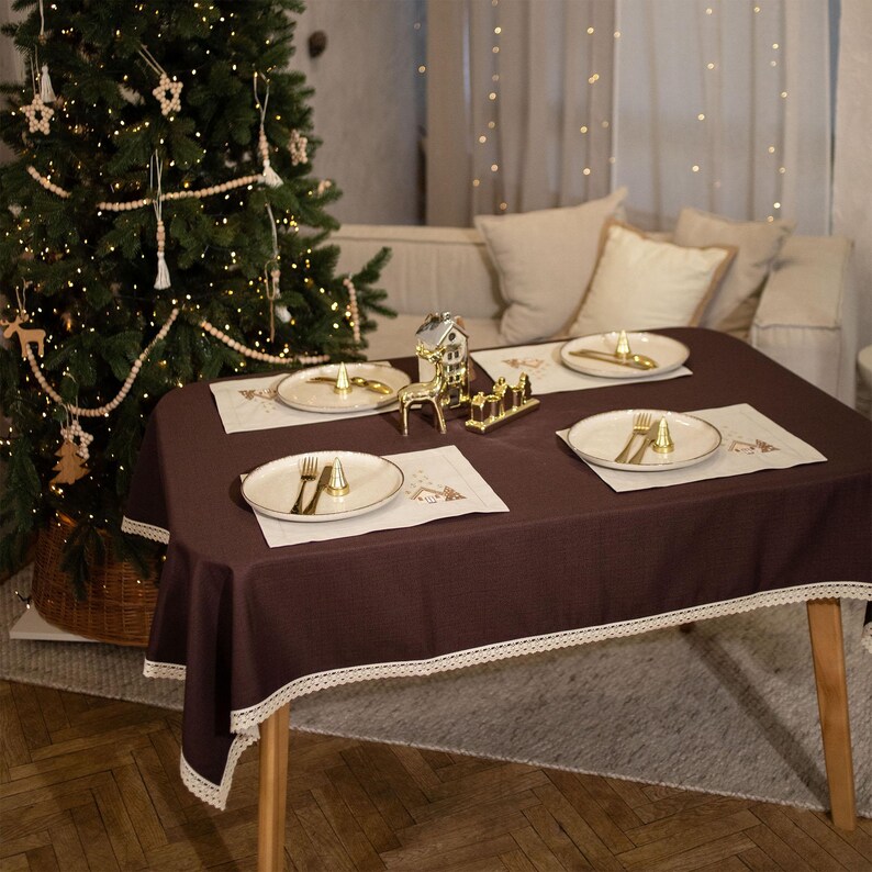 Christmas table napkin with embroidered gingerbread house design
