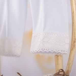 May include: White leggings with a white lace trim at the bottom.
