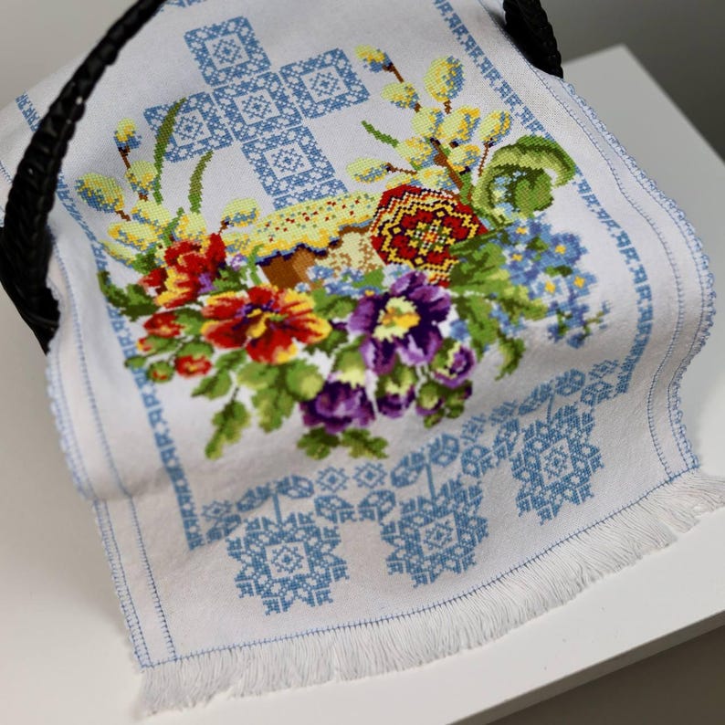 Easter basket cover with blue cross embroidery and spring floral design