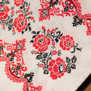 Handmade embroidered towel with red rose motifs and lace trim