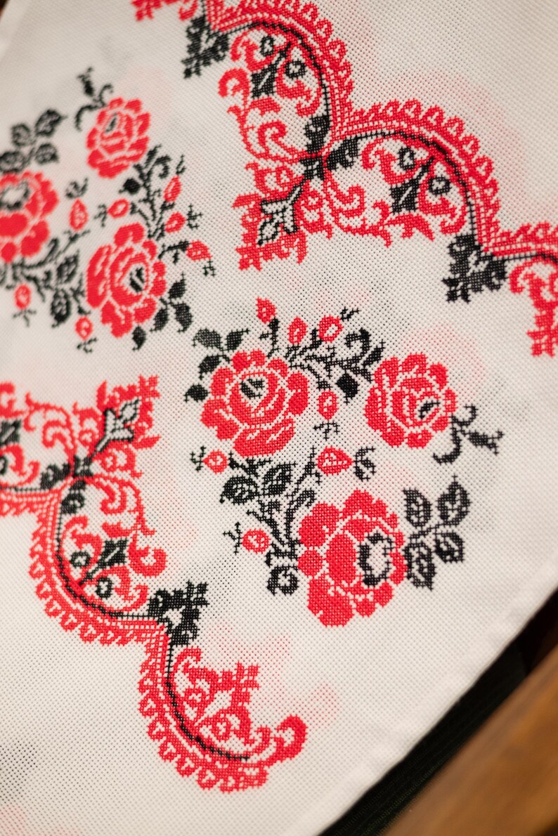 Handmade embroidered towel with red rose motifs and lace trim