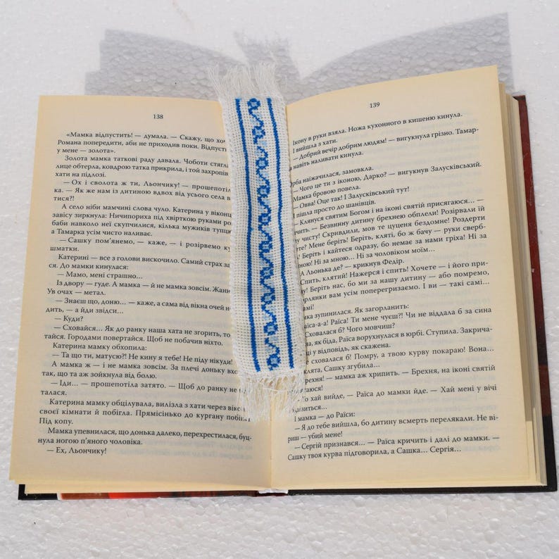 Embroidered fabric bookmark with blue cross stitch