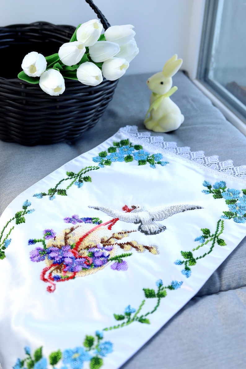 Beaded cover with bird