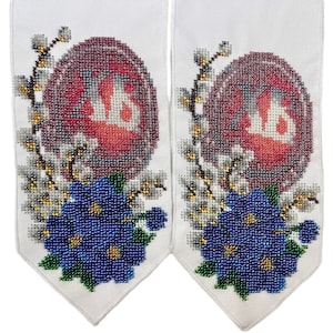 May include: Two white fabric panels with embroidered designs. Each panel features a red egg shape with the letters "XB" in white, surrounded by white and gold floral accents and blue beaded flowers.