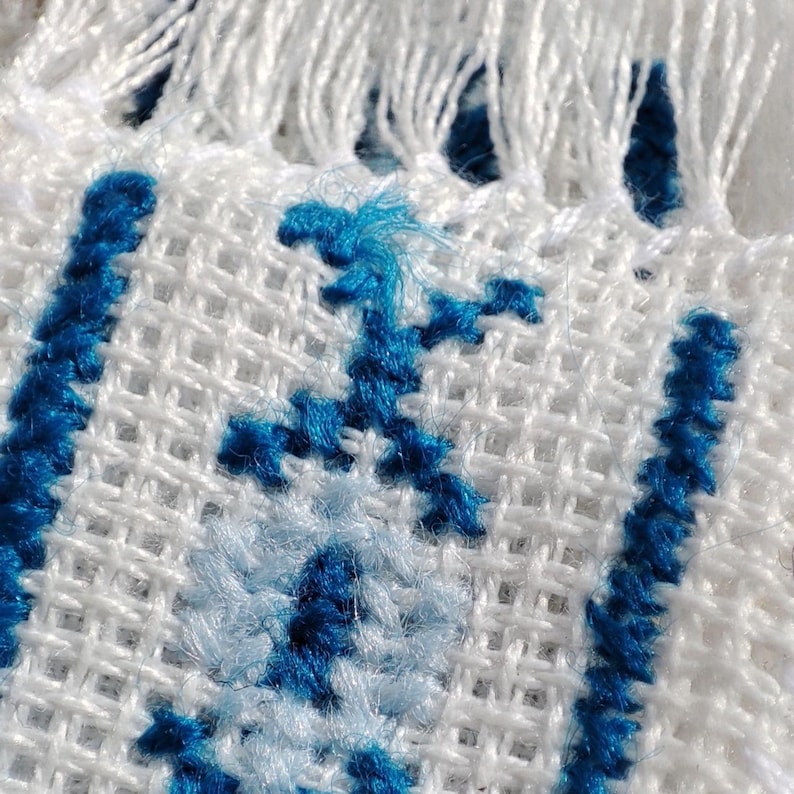 Embroidered fabric bookmark with blue cross stitch