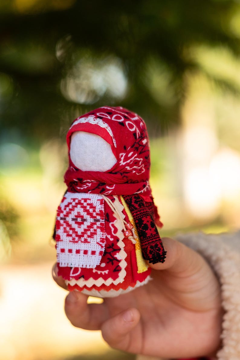 Traditional cloth doll in yellow with floral embroidery