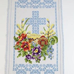 Easter basket cover with blue cross embroidery and spring floral design
