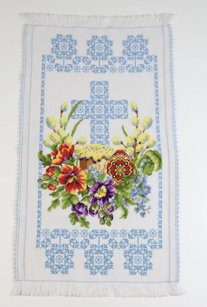 Easter basket cover with blue cross embroidery and spring floral design