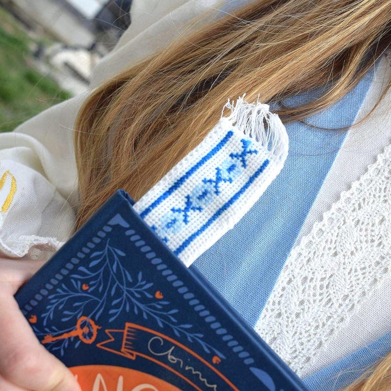 Embroidered fabric bookmark with blue cross stitch