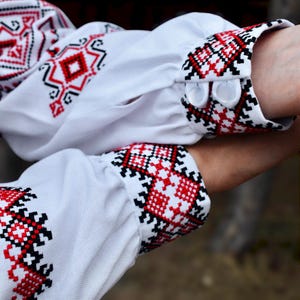White Folk Embroidered Blouse with Red and Black Geometric Patterns – Long Sleeve Traditional Peasant Shirt for Women with Tassel Tie Detail