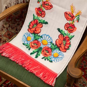Hand-embroidered table runner with vibrant floral design