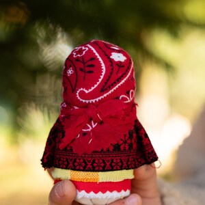 Traditional cloth doll in yellow with floral embroidery