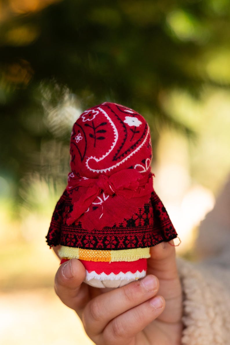 Traditional cloth doll in yellow with floral embroidery