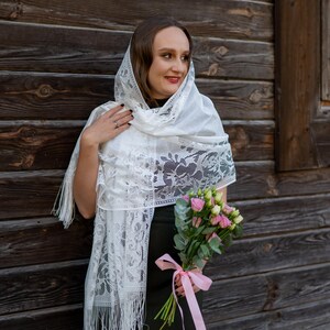 Elegant white lace shawl with fringe