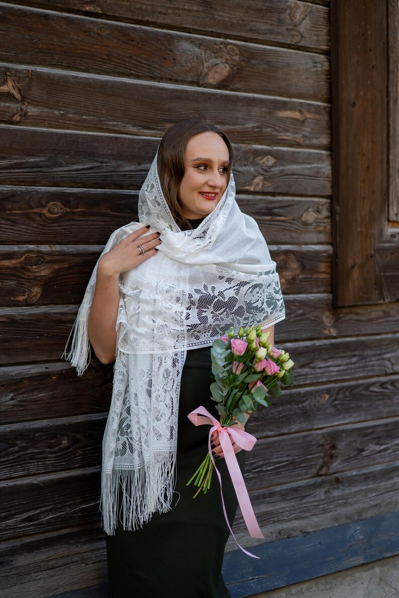 Elegant white lace shawl with fringe