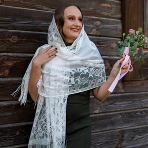 Elegant white lace shawl with fringe