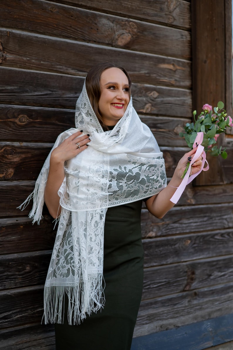Elegant white lace shawl with fringe