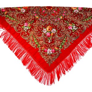 May include: A red shawl with a floral pattern and gold accents. The shawl has a fringe border.