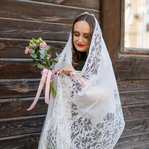 Elegant white lace shawl with fringe