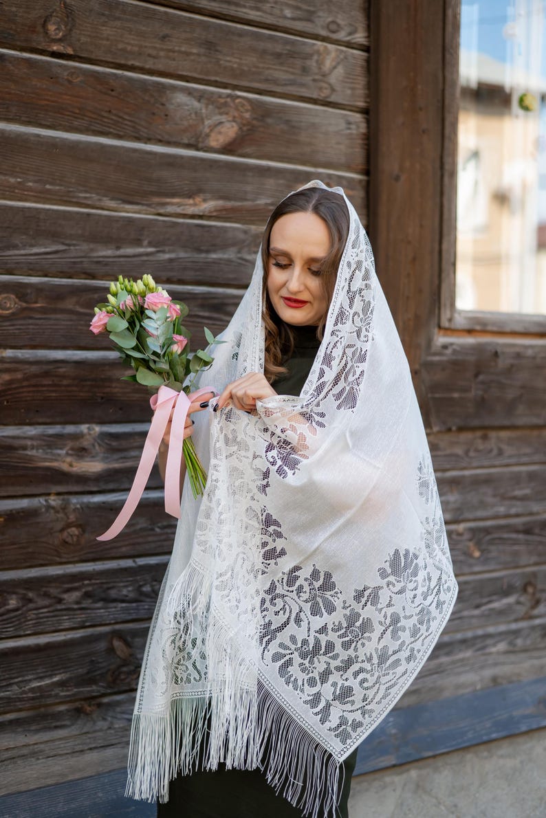 Elegant white lace shawl with fringe