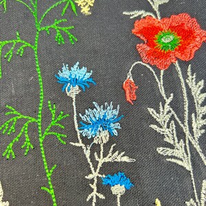 Black canvas tote with embroidered wildflowers, poppies and cornflowers, reusable cotton shoulder bag for shopping, books, market and gifts