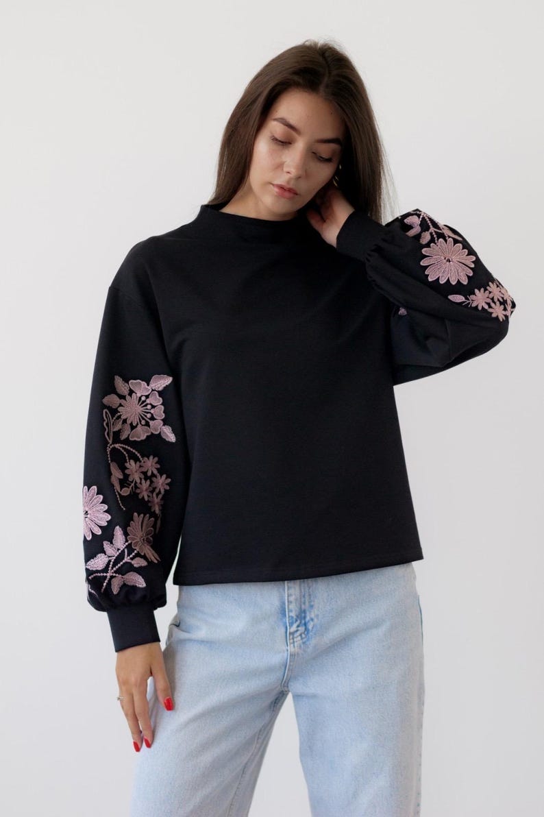 Black sweatshirt with pink floral embroidered sleeves