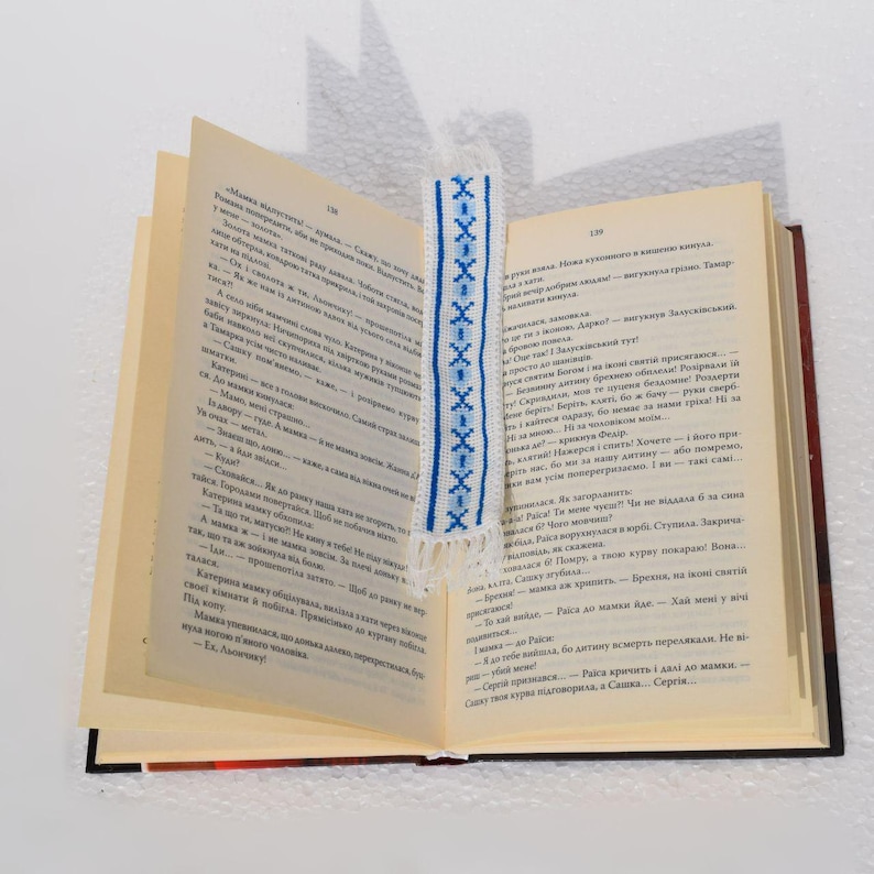 Embroidered fabric bookmark with blue cross stitch