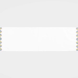 May include: White fabric scarf with a colorful embroidered design featuring geometric shapes and floral patterns. The design is repeated on both ends of the scarf.