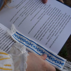Embroidered fabric bookmark with blue cross stitch