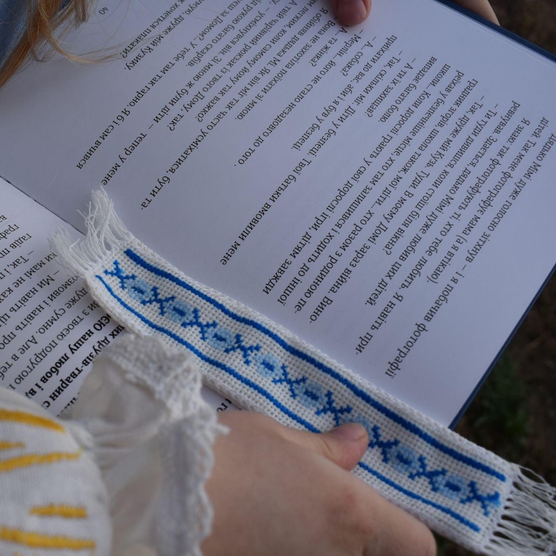 Embroidered fabric bookmark with blue cross stitch