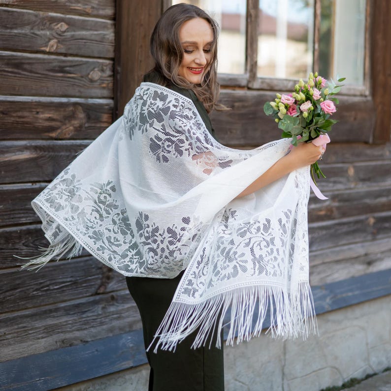 Elegant white lace shawl with fringe