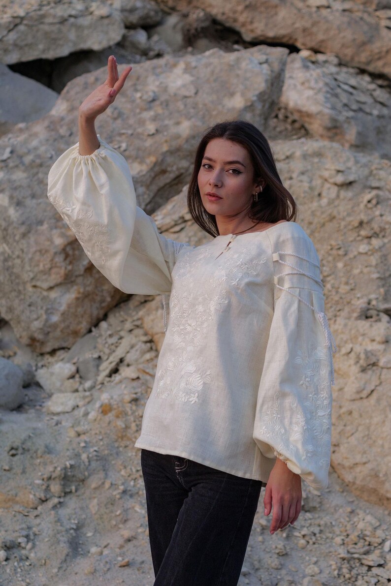 Ivory linen blouse with puffy sleeves and intricate white embroidery