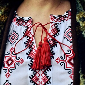 White Folk Embroidered Blouse with Red and Black Geometric Patterns – Long Sleeve Traditional Peasant Shirt for Women with Tassel Tie Detail