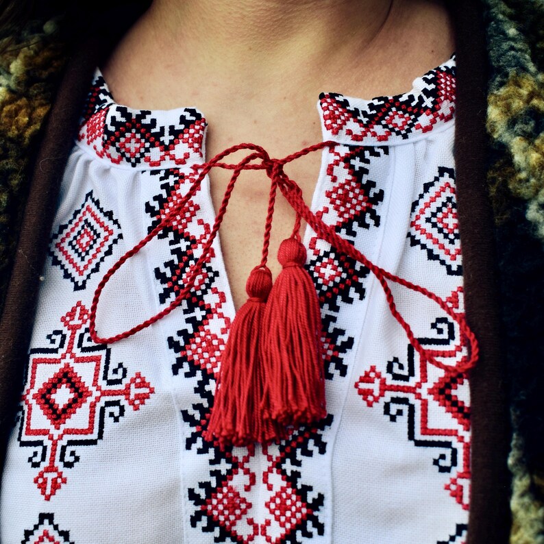 White Folk Embroidered Blouse with Red and Black Geometric Patterns – Long Sleeve Traditional Peasant Shirt for Women with Tassel Tie Detail