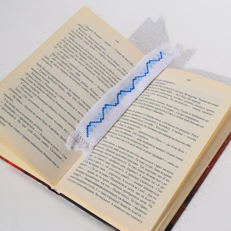 Embroidered fabric bookmark with blue cross stitch
