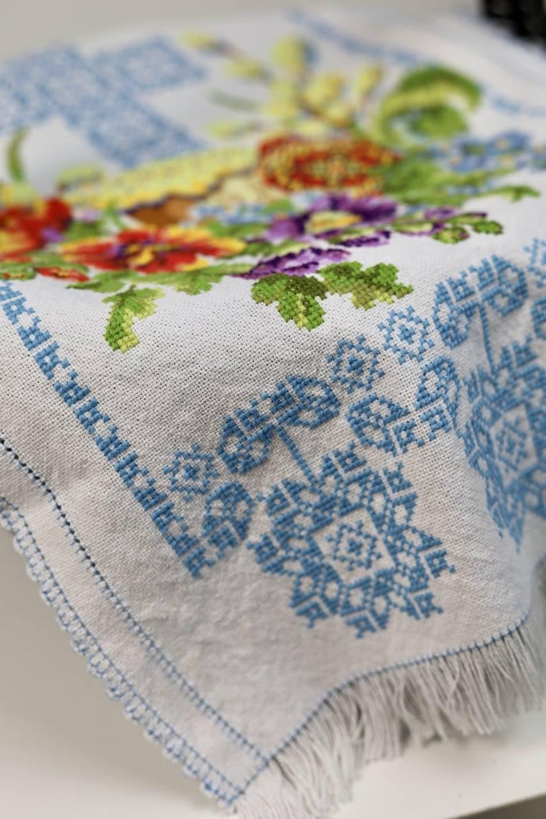 Easter basket cover with blue cross embroidery and spring floral design