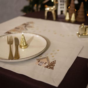 Christmas table napkin with embroidered gingerbread house design