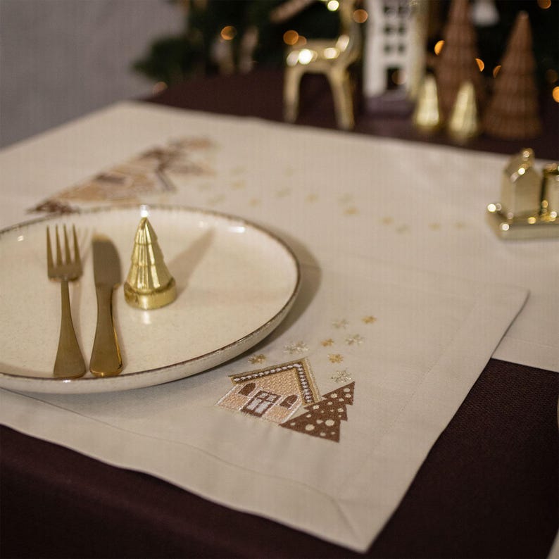 Christmas table napkin with embroidered gingerbread house design