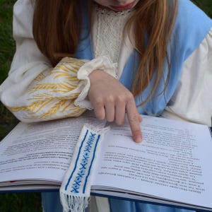 Embroidered fabric bookmark with blue cross stitch