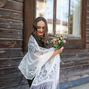Elegant white lace shawl with fringe