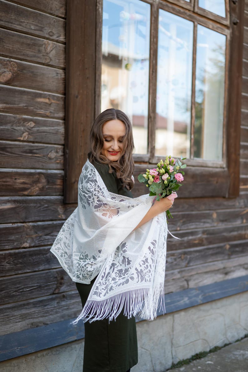 Elegant white lace shawl with fringe
