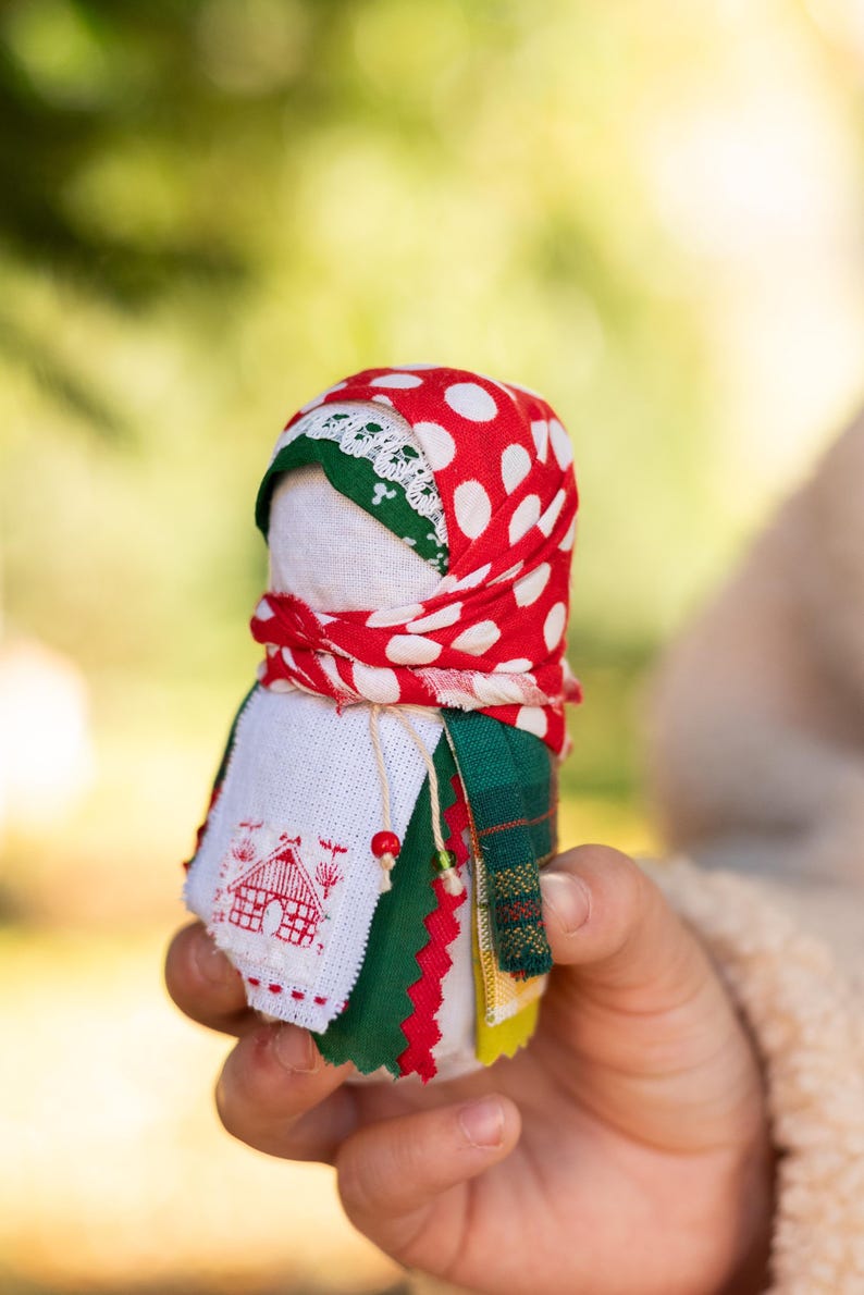 Traditional cloth doll in yellow with floral embroidery