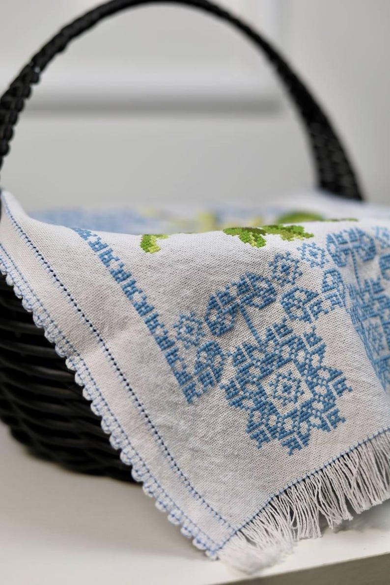 Easter basket cover with blue cross embroidery and spring floral design