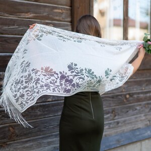 Elegant white lace shawl with fringe