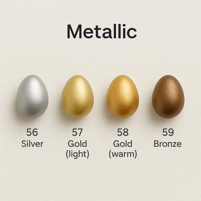 May include: Four metallic egg-shaped objects in silver, light gold, warm gold, and bronze. The word "Metallic" is above the eggs. Each egg is labeled with a number and color description: Silver, Gold (light), Gold (warm), and Bronze.