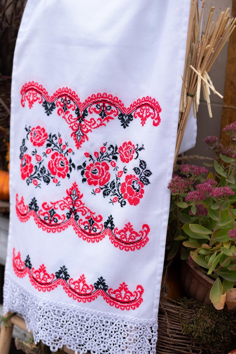 Handmade embroidered towel with red rose motifs and lace trim